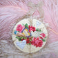 A Mixed Media Decoration with an Antique Die Cut displaying a dove, lots of flowers and the phrase LIFE BEAR FOR YOU ITS SWEETEST FLOWERS. Blank back.